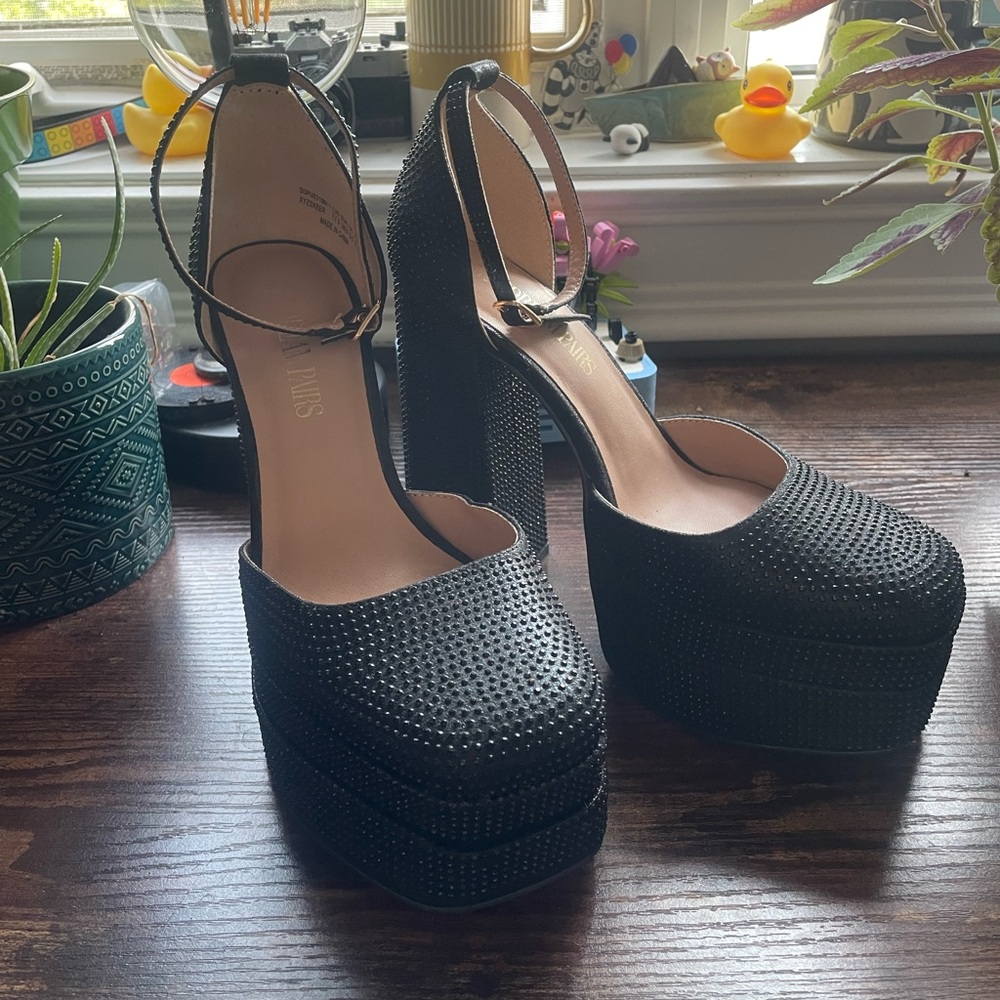 Black Platform Heels with black gens all over it